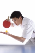 Young man playing table tennis, preparing to serve - blueduck