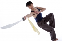 Young man practicing martial arts, holding sword - blueduck