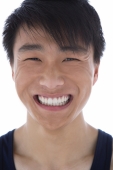 Young man smiling at camera, head shot - blueduck