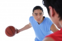 Two men playing basketball, over the shoulder view - blueduck