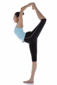 Female gymnast standing on one leg, holding other foot behind her head - blueduck