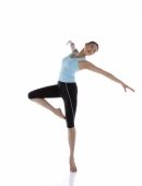 Female gymnast standing on one leg, arms outstretched - blueduck