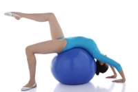 Gymnast balancing on fitness ball - blueduck
