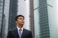 Businessman looking away, buildings in the background - blueduck