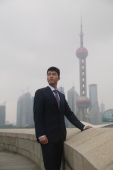 Businessman looking away, Oriental Pearl TV Tower in the background - blueduck