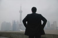 Businessman looking at Oriental Pearl TV Tower in the background - blueduck