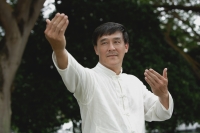Man in park doing Tai Chi, martial arts - Yukmin