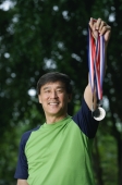 Man holding medals, winner, smiling - Yukmin