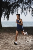 Man running along beach, workout - Yukmin