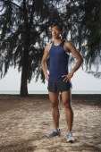 Man standing in park along beach after running - Yukmin