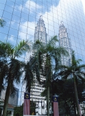 Petronas Towers reflected on the curtain wall of a commercial building, Kuala Lumpur, Malaysia - OTHK