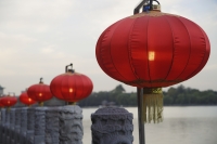 Chinese lanterns next to water - Alex Mares-Manton
