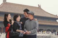 A family pose for photos together in front of The Forbidden City, Beijing - Alex Mares-Manton