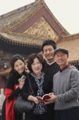 A family look at the camera as they pose in front of The Forbidden City, Beijing - Alex Mares-Manton