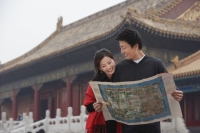 A tourist couple look at a map together in front of The Forbidden City, Beijing - Alex Mares-Manton