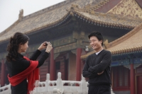 A couple take photos of each other in front of The Forbidden City, Beijing - Alex Mares-Manton