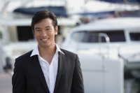 Man in front of yacht, smiling at camera - Yukmin