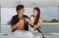 Couple on yacht, toasting with glasses - Yukmin