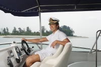 Man on yacht, smiling at camera - Yukmin