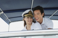 Young couple on yacht, smiling at camera - Yukmin
