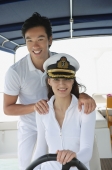 Young couple on yacht, smiling at camera - Yukmin