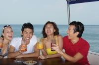 Young people on yacht having drinks - Yukmin