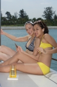 Two young women on a yacht, smiling at the camera - Yukmin