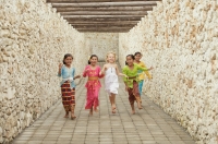 Balinese girls running with Caucasian girl - Cedric Lim