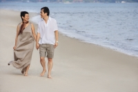 Mature couple walking at the beach - Alex Mares-Manton