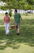 Mature couple in the park going for a picnic - Alex Mares-Manton