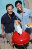 Father and son enjoying barbeque - Alex Mares-Manton