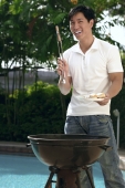 Young man having a barbeque - Cedric Lim