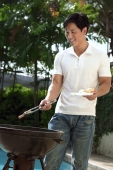 Young man having a barbeque - Cedric Lim