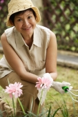 Woman doing gardening while smiling at camera - Cedric Lim