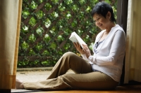 Woman reading book in the garden - Cedric Lim