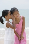 Girl whispering into sister's ear - Yukmin