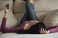 Young woman listening to music - Yukmin