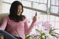 Young woman using mobile phone - Yukmin