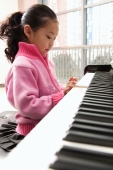 Young girl playing piano - Alex Mares-Manton