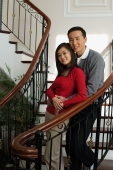 Young couple on stairs smiling at camera - Alex Mares-Manton