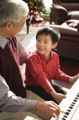 Grandfather and grandson playing piano - Alex Mares-Manton