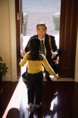 Girl greeting father at doorstep - Alex Mares-Manton