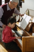Boy playing piano for grandfather - Alex Mares-Manton