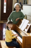 Girl playing piano for grandmother - Alex Mares-Manton