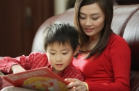 Mother and son looking at children's book - Alex Mares-Manton