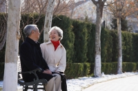 Elderly couple sitting on park bench - Alex Mares-Manton