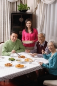 Family at dinner table having traditional food - Alex Mares-Manton