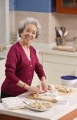 Elderly woman baking in the kitchen - Alex Mares-Manton