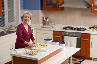 Elderly woman baking in the kitchen - Alex Mares-Manton