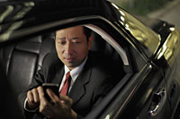 mature man sitting in a car texting on phone - Alex Mares-Manton